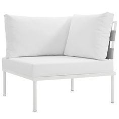 a white couch with two pillows on it's back and one pillow in the middle