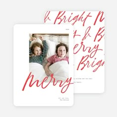 two children laying in bed with the words merry on it and red lettering over them