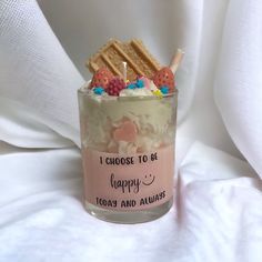 a small glass jar filled with cake and marshmallows