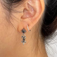 Introducing our Victorian Style Fleur De Lis Dangle earrings, crafted with intricate detail in titanium. These statement pieces are inspired by the iconic style of Chrome Heart, perfect for expressing your unique and bold personality. Add a touch of rebellious charm to your outfit with these striking earrings that are sure to turn heads wherever you go. Elevate your accessory game with these must-have pieces that exude a sense of edgy sophistication. ▪️▪️▪️PRODUCT Sold by pair=2pcs AAA Cubic Zirconia Titanium Hypoallergenic, Lead & Nickel Free VISIT STORE FOR MORE PRODUCT 🔗 https://www.etsy.com/ca/shop/TWISTEEL ▪️▪️▪️ S H I P P I N G   All orders will be shipped on the next business day UNITED STATES  - USPS First-Class Mail * 4 - 14 Business Days  Tracking & Insurance included CANADA - C Formal Drop Cartilage Earrings, Gothic Single Earring As Gift, Gothic Single Drop Earring, Gothic Drop Earrings Pierced, Gothic Drop Earrings, Chrome Hearts Earring, Vampire Aesthetics, Vampire Earrings, Victorian Style Earrings