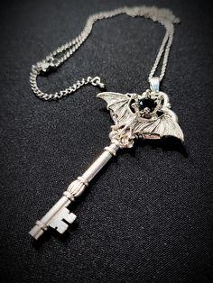 Key Necklace Vampire Bat With Black Crystal Gothic jewelry accessory, beautiful gift for many occasions: party, ball, wedding, date, cosplay event... Big silver plated key with little vampire bat and a black Swarovski crystal. Size of the pendant: 9 cm Size of the chain: 70 + 5 cm Vampire Items, Vampire Accessories, Imp Oc, Necklace Vampire, Little Vampire, Key Necklaces, Vampire Necklace, Vampire Jewelry, Witchy Style