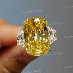 Handmade 22.3 TCW Canary Yellow cushion cut moissanite engagement ring,three stone moissanite ring,trapezoid&large big elongated cushion wedding ring → Occasions: Engagement & Wedding DESCRIPTION  -------------------- STYLE                                     :Three stone ●𝐂𝐞𝐧𝐭𝐞𝐫 𝐒𝐭𝐨𝐧𝐞 𝐃𝐞𝐭𝐚𝐢𝐥𝐬 →Stone Type      :Moissanite - High Quality →Main Stone      :Cushion (Canary Yellow) →Size (mm)        :19*12 →Carat Weight   :20  ●𝐌𝐚𝐢𝐧 𝐬𝐭𝐨𝐧𝐞 𝐨𝐩𝐭𝐢𝐨𝐧 𝐢𝐧 𝐂𝐓 17 CT = 18. Cushion Wedding Ring, Elongated Cushion Cut Engagement Ring, Engagement Ring Three Stone, Cushion Cut Moissanite Engagement Ring, Moissanite Engagement Ring Cushion Cut, Faberge Jewelry, Yellow Cushion, Ring Three Stone, Yellow Sapphire Rings