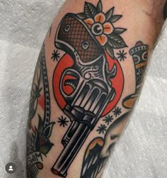 a close up of a person with a tattoo on their arm holding a motorcycle helmet