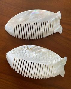 Antique from 1950s, handcrafted, %100 mother of pearl, fish shaped hair combs / brushes / ornaments; sold as pair. *Excellent vintage condition  *Made in Greece *This naturally beautiful, anti-static hair combs hand carved from mother of pearl *Exclusive natural crystal for oldest beauty & self care routine & hair growth *Hancrafted and shaped as a fish so every individual piece  is one of a kind *They have smooth surface, semi-transparent to light & natural  stone color *Perfect as unique gift for bridal or baby shower, weeding, Valentine's Day Mother's Day or any other special occasion *No chips, cracks or scratches *They measure; 11 cm / 12 cm Notes: Sold in pair. Your item(s) will be wrapped with care to ensure safe arrival. Feel free to contact me with any questions. International shi Mermaidcore Hair Accessories, Beauty Self Care, Antique Hairbrush, Natural White Hair, Mother Of Pearl Hair Comb, Vintage Hair Comb, Static Hair, Pearl Comb, Vintage Comb