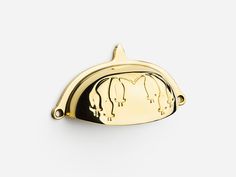 a gold plated elephant shaped object on a white background