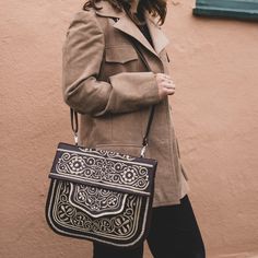 In Morocco, hand embroidery serves as a thread connecting generations, with mothers teaching daughters the craft. Embroidered designs can be found on various items in the souks—from handkerchiefs to poufs and bags—and the designs differ from city to city. This satchel, the perfect size for books, has proven itself a versatile companion for any adventure. 11" tall, 12" wide Detachable shoulder strap Embroidered leather Embroidered Brown Rectangular Satchel, Brown Embroidered Rectangular Satchel, Artisan Embroidered Tote Shoulder Bag, Traditional Embroidered Satchel Bag, Artisan Embroidered Shoulder Bag For Travel, Embroidered Brown Tote Satchel, Brown Embroidered Tote Satchel, Brown Embroidered Satchel For Travel, Traditional Embroidered Shoulder Bag For Travel