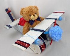 a teddy bear sitting on top of an airplane