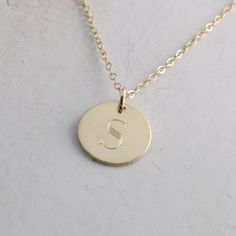 "Solid gold engraved initial necklace is a family heirloom that will be cherished and treasured for many years... it is the PERFECT gift! PICTURE IS ENLARGED TO SHOW DETAIL! SEE SECOND PICTURE FOR SIZE COMPARISON. PLEASE READ BELOW FOR ACTUAL MEASUREMENTS!! Your choice of one, two, or three solid gold 1/2\" (13mm) discs have been personalized just for you with a classy block font in a large 7mm size and it is GORGEOUS! (Font is shown in picture #6 above) The pendants hang from a solid 14k gold 1 Classic Initial Necklace As A Gift, Classic Engraved Initial Necklace As Gift, Classic Round Pendant Initial Necklace For Anniversary, Classic Engraved Initial Necklace For Gift, Classic Initial Pendant Necklaces As Gift, Classic Initial Necklace As Personalized Gift, Classic Personalized Initial Pendant Jewelry, Classic Necklaces With Initials On Round Pendant, Classic Monogram Necklaces For Personalized Gift