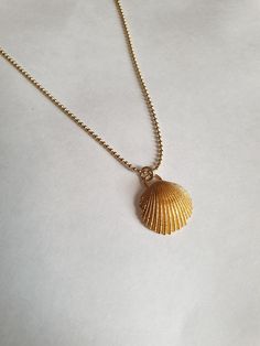 A sea shell necklace made of natural shells casted in brass and plated with quality, nickel free 14k gold plating. The necklace is made of 14k gold filled. Gold Shell Necklace With Clavicle Chain, Gold Shell-shaped Necklace With Clavicle Chain, Gold Shell-shaped Necklace, Gold Minimalist Necklace For Beach, Minimalist Gold Necklaces For The Beach, Minimalist Gold Necklace For Beach, Gold Shell Necklace In Ocean-inspired Style, Dainty Gold Shell Charm Necklace, Gold Ocean-inspired Shell Necklace