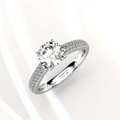 a diamond engagement ring on a white background