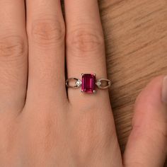 It is a lab ruby ring. The main stone is 6 mm*8 mm emerald cut.weight about 1.7 carats. The basic metal is sterling silver and plated with rhodium. To change the metal to a solid gold (white/rose) or platinum is also available, please ask for a quotation if you want. You can also go to my shop Home for more elegant rings: https://www.etsy.com/shop/godjewelry?ref=hdr_shop_menu Ruby is July birthstone More ruby rings: https://www.etsy.com/shop/godjewelry?ref=seller-platform-mcnav&section_id=20 Red Ruby Ring, Red Gemstone Ring, Elegant Rings, January Birthstone Rings, Red Garnet Ring, Star Garnet, Ring Emerald Cut, Ruby Rings, Silver Anniversary