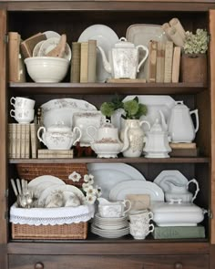 an old china cabinet filled with dishes and plates