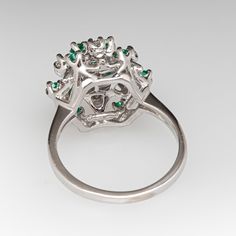 a white gold ring with emeralds and diamonds