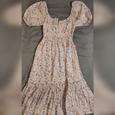 an old fashioned dress is laying on a bed