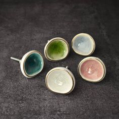 four different colored bowls sitting on top of a table