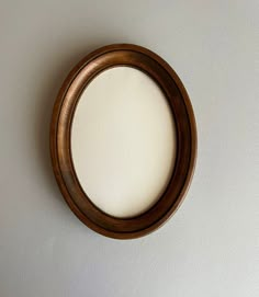 a round mirror hanging on the wall