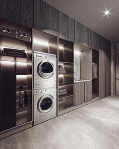 a washer and dryer are in the middle of a room with mirrored doors