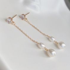 * DETAILS * This listing is a pair of earrings only.  - Freshwater Pearl - 14K Gold Plated CZ Post Earrings  - 14K Gold Plated Chain 👉🏻For more earrings, see https://www.etsy.com/shop/JinnysJewelryBySeJin ✨matching earrings. https://www.etsy.com/JinnysJewelryBySeJin/listing/1259483823/freshwater-pearl-earrings-bridal?utm_source=Copy&utm_medium=ListingManager&utm_campaign=Share&utm_term=so.lmsm&share_time=1656461065010 👉🏻You may also like matching necklace. https://jinnysjewelrybysejin.etsy.c Formal Gold Pearl Earrings In 14k Gold Filled, Elegant 14k Gold Filled Jewelry For Wedding, 14k Gold Dangle Bridal Earrings As Gift, Elegant Gold Plated Linear Earrings For Anniversary, White 14k Gold Filled Bridal Earrings For Wedding, Elegant Gold Hypoallergenic Crystal Earrings, Elegant Gold Crystal Hypoallergenic Earrings, Gold Long Drop Bridal Earrings, Gold Long Drop Bridal Earrings For Formal Occasion