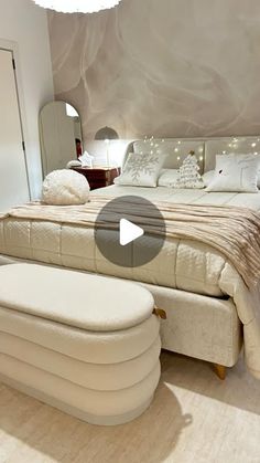 a bed room with a neatly made bed and a large mirror on the wall above it