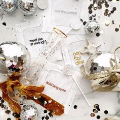 a table topped with lots of silver and gold confetti covered in glitters