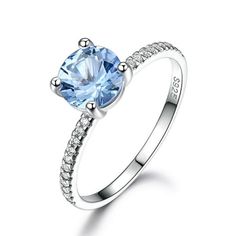 The Created Sky Blue Topaz Engagement Ring from the Ginger Lyne Collection is a testament to timeless elegance and contemporary design. This stunning ring features a lab-created sky blue topaz, boasting a serene 7mm stone that captures the essence of a tranquil sky. The vibrant blue of the topaz is beautifully contrasted with the sparkling clarity of AAA quality cubic zirconia accents, creating a captivating display of color and brilliance. Crafted with .925 sterling silver, this ring benefits f Sky Blue Topaz Engagement Ring, Topaz Birthstone, Gemstone Wedding, Blue Topaz Engagement Ring, Topaz Engagement Ring, Blue Topaz Stone, January 23, Square Rings, Sky Blue Topaz