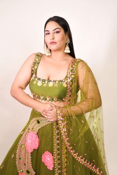 Introducing a tulle lehenga in olive, adorned with glass beads, metals, sequins, and 3D embroidered flowers. Paired elegantly with an olive raw silk blouse embellished with shell stones, crystals, and metals, along with a complementing tulle dupatta. This ensemble combines intricate detailing with a touch of glamour for a captivating look. Tulle Lehenga, Raw Silk Blouse, Personal Shopping Service, Embroidered Lehenga, Indian Design, Raw Silk, Green Fabric, Handmade Clothes, Personal Stylist