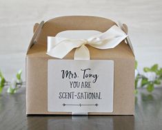 a brown box with a white bow on it and a tag that says, mrs tony you are sent - stational