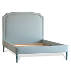 an upholstered blue bed frame with wooden slats