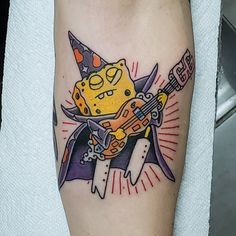 a cartoon character with a guitar tattoo on his leg