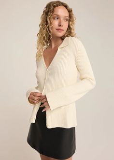 Elevate your look in our collared long sleeve sweater, featuring soft ribbed sweater yarns and a classic button-up front. Perfect for layering or wearing solo, this piece combines comfort and style effortlessly. Collared. Long sleeve. Midweight. Regular fit. Dancer Yarns - 2X2 Rib: 52% Viscose, 26% Polyester, 22% Nylon. Model is wearing a size S. Ribbed Button-up Outerwear For Layering, Ribbed Knit Button-up Outerwear, Elegant Ribbed Button-up Cardigan, Ribbed Collared Sweater For Winter, Winter Collared Ribbed Sweater, Winter Ribbed Collared Sweater, Fall Polo Sweater With Ribbed Collar And Button-up, Chic Ribbed Polo Sweater For Winter, Chic Button-up Cardigan With Ribbed Collar