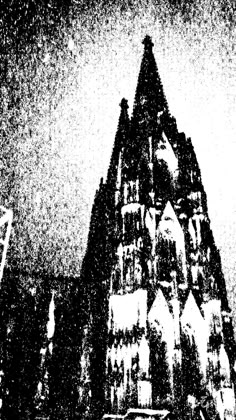 an old black and white photo of a church steeple in the night time with snow falling on it