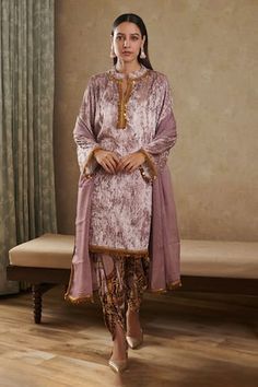 Pink velvet kurta featuring lace detailing on the neckline and sleeve hems. Paired with an abstract printed dhoti pant and a coordinating dupatta., Fit: Relaxed Traditional Velvet Sets With Sheer Dupatta, Fitted Velvet Sharara With Traditional Drape, Velvet Fitted Sharara With Traditional Drape, Fitted Velvet Sharara With Zari Work, Fitted Velvet Traditional Wear With Dupatta, Velvet Saree Set With Sheer Dupatta, Eid Velvet Fitted Dupatta, Fitted Velvet Sharara For Eid, Velvet Fitted Sharara For Eid