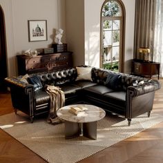 a living room filled with black leather furniture