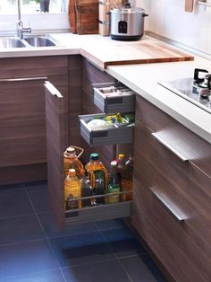 an open cabinet in the middle of a kitchen