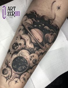 an artistic tattoo with planets and stars on the arm, done in black and white