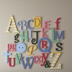 wooden alphabet letters are arranged in different colors