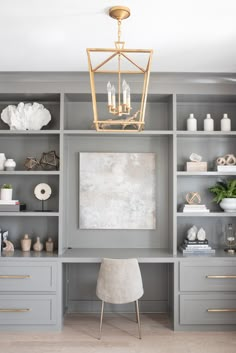 a room with gray shelves and gold accents