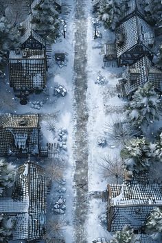 an aerial view of snow covered houses and trees