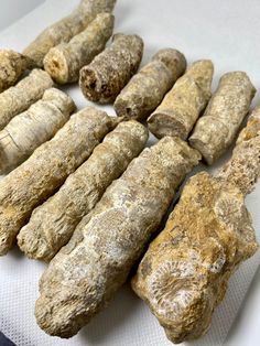 several different types of dog treats on a white table cloth next to eachother