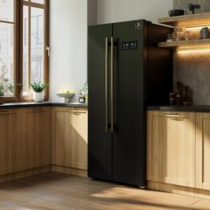 a black refrigerator freezer sitting inside of a kitchen