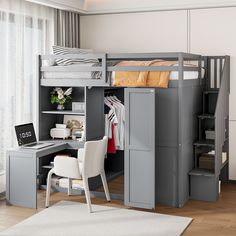 a loft bed with desk underneath it and stairs leading up to the top bunkbed