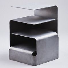 a three tiered metal shelf on white background