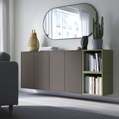 a living room with a book shelf and mirror