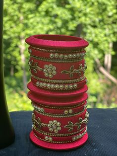 This set of 20 beautiful silk thread bangles are perfect for adding a touch of boho and hippie style to any look. Handmade with plastic, these bangles come in a size of 2.4 inches. Features: - 20 beautiful silk thread bangles - Adds a touch of boho and hippie style - Handmade with plastic - Size 2.4 inches Bohemian Adjustable Bangle For Diwali, Thread Bangle Gift For Festivals, Traditional Thread Bracelets For Festive Occasion, Bohemian Bracelets For Diwali Party, Thread Bangle As A Gift For Festivals, Traditional Thread Bracelets For Festivals, Adjustable Bohemian Bangle For Festive Season, Handmade Bangle For Festive Occasions, Festive Thread Bangle Bracelets