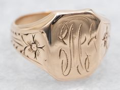 This antique signet ring has a lovely refined look to it. The sweet daisy flowers along the shoulders give just enough texture to draw the eye, without being ostentatious. We've left the original monogram "M" done in beautiful French Script. Please note that this signet ring has its original monogram, unfortunately, this piece cannot be altered without affecting the quality of the piece, please feel free to contact us to help you find your perfect signet ring in your style and budget! Metal: 14K Antique Rose GoldTop Measurements: 12 x 9 mm, Rectangle Monogram: "M" in French ScriptRing Size: 4Marks: "14K" Stamped on the inside band French Script, Daisy Flowers, Antique Roses, Daisy Flower, Signet Ring, The Sweet, The Eye, To Draw, Daisy