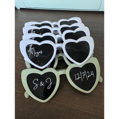 many heart shaped sunglasses with writing on them