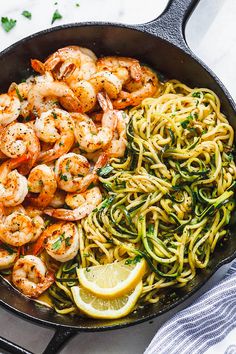 pasta with shrimp, lemon and spinach in a skillet