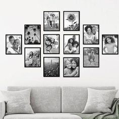 a living room with a couch and many pictures on the wall above it, all in black and white