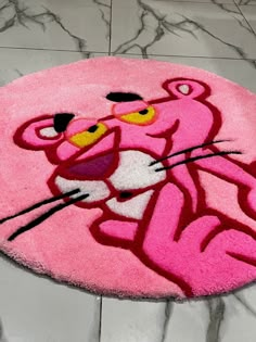 a pink rug with an image of a cartoon cat on it's face and eyes