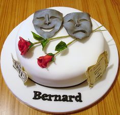 a cake decorated with two faces and roses on it's side that says bernard